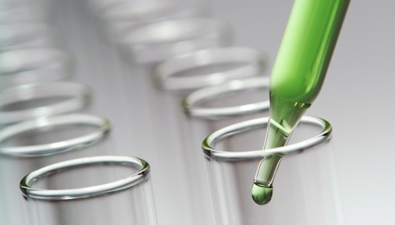 Green chemical being put into test tubes